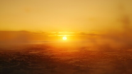 Obraz premium Golden Sunset Over a Misty Landscape