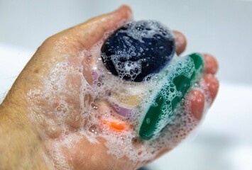 Fototapeta premium Used soaps glued together to form a ball. Ball of Used Soaps of different colors. economy and use