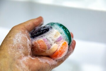 Fototapeta premium Used soaps glued together to form a ball. Ball of Used Soaps of different colors. economy and use