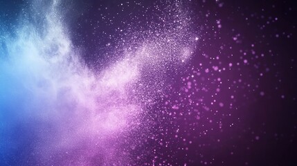 Obraz premium Abstract swirling purple and blue powder explosion on black background.