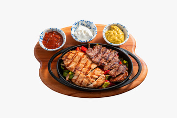 Combo fajitas pan with chicken and beef steak stripes, sweet pepper and onions. Isolated on white background
