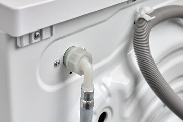 Top view  of a hose for connecting cold water to a washing machine in a house or apartment. Washer...