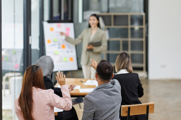 Business Asian people, laptop and conversation with research, teamwork and connection in the office. Group, employees and accounting with computer, internet and cooperation with meeting and planning