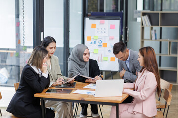 Business Asian people, laptop and conversation with research, teamwork and connection in the office. Group, employees and accounting with computer, internet and cooperation with meeting and planning