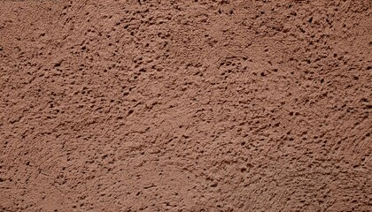 Close-up of a textured brown plaster wall with uneven surface.