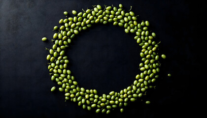 Obraz premium A circular arrangement of green seeds on a dark background, creating a visually striking pattern. This image is perfect for themes related to nature, healthy eating, and organic products
