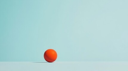 Single orange sphere on light blue background.