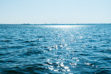 Beautiful seascape with blue sky on a sunny day. Nature background. Sea surface in sun light....