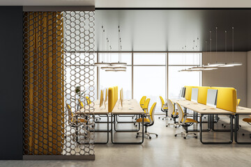 Modern coworking office interior with yellow chairs, long desks, and computers, featuring a decorative partition and city view windows. 3D Rendering