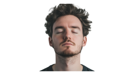 Young man with closed eyes and tousled hair meditating in a serene indoor environment, creating a peaceful atmosphere.