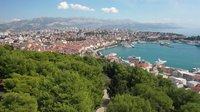 A stunning aerial view of Marjan Hill's first viewpoint, offering a breathtaking panorama of the sunlit city of Split, surrounded by the sparkling Adriatic Sea and scenic Dalmatian landscapes.