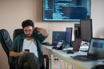 A programmer diligently testing smartphone applications 