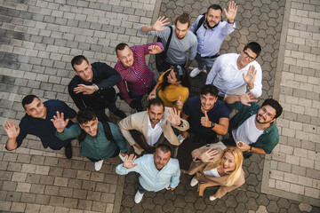 Top view photo of a group of business people and colleagues standing together holding hands,...