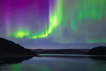Naklejka premium Northern lights in the glacier of Qaleraliq (South Greenland) 