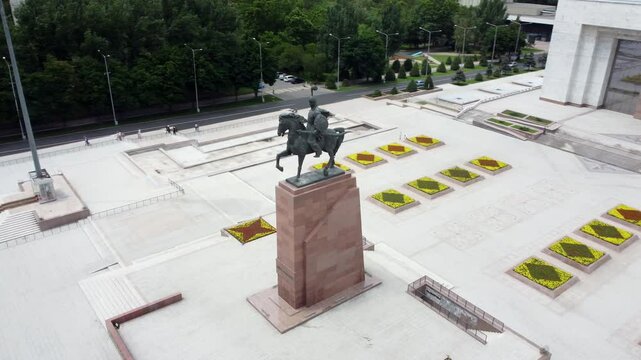 Aerial circling shot of the statue of Manas in Ala Too Square in Bishkek, Kyrgyzstan