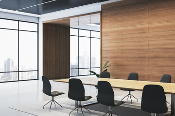 Modern boardroom with wooden accents, large windows, and black chairs around a sleek table in a spacious interior. 3D Rendering