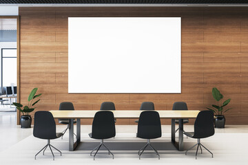 Modern conference room with blank white poster on wooden wall, minimalist interior design with chairs and table. 3D Rendering