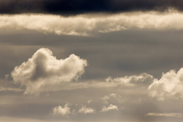 Very close view of dense cumulus clouds over the western Andean  mountains of  central Colombia, illuminated by sunlight of the afternoon.