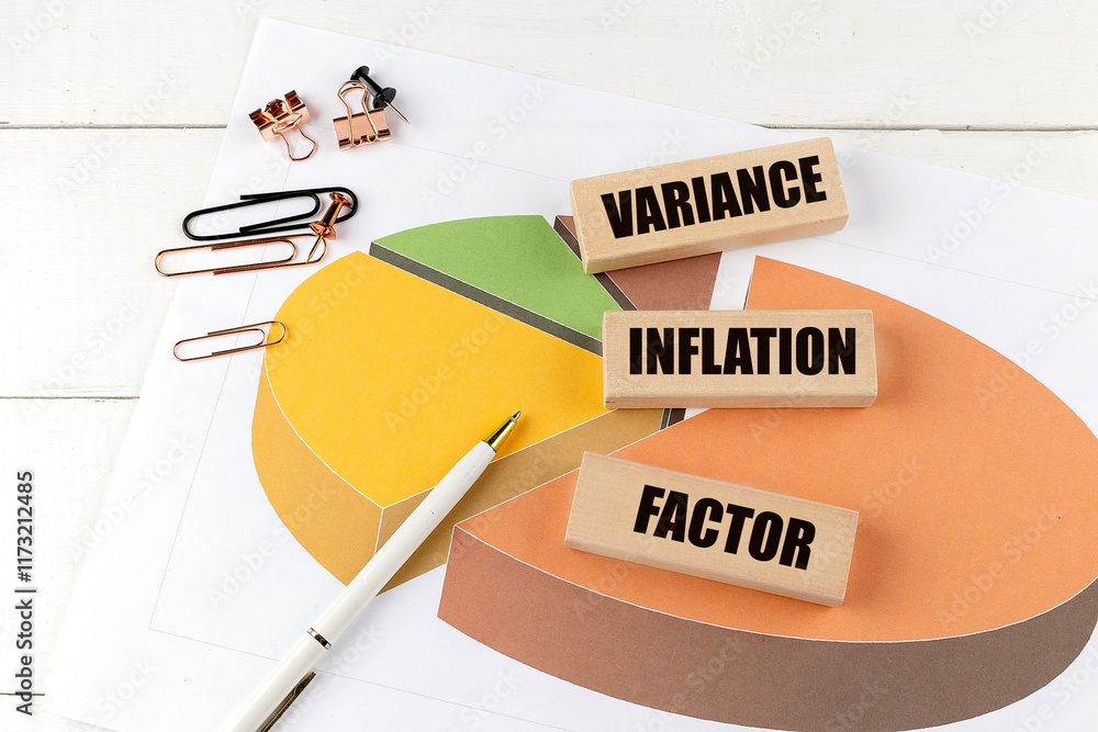 Poster variance inflation factor concept with wooden blocks on a pie chart surrounded by paperclips and a p