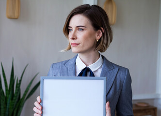 businesswoman holding an empty white board with free copy space for text, idea and innovation, business concept