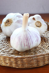 Garlic bulb. Wicker basket with cloves. Brazilian seasonigns.
