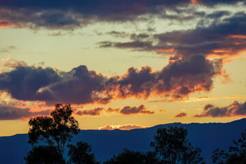 The end of the sunset fills the sky with the colors of an awesome  afterglow, over the western Andean mountains of central Colombia.