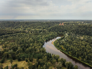 drone view of the river meandering through the woods
