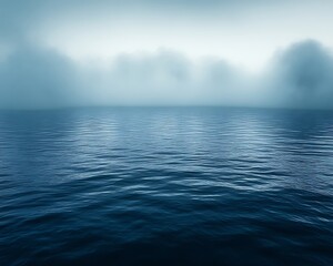 Misty lake, calm water, blurred trees.