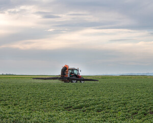 Spraying pesticides at soy bean fields