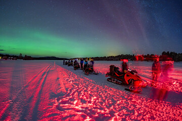 Snowmobile expedition Aurora Northern Lights in Lapland Inari Nellin Lake forest