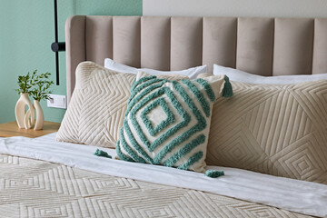 An Elegant Bedroom Featuring Textured Pillows and a Soft and Inviting Color Palette