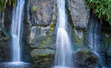 Tropical Waterfall with Black Lava Rock Background.