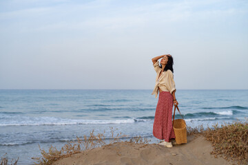 Woman Standing on Dune Looking at the Sea