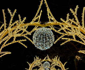 Central street is decorated with unique glowing New Year installations. Garland bulbs glow with multi-colored lights. Fragments of glowing static structures. Krasnodar, Russia - December 24, 2024