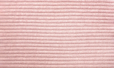 Light pink knit cotton fabric close up, horizontal background 