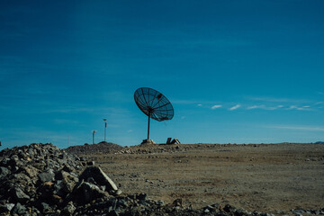 Large satellite dish in a remote desert landscape, Chile