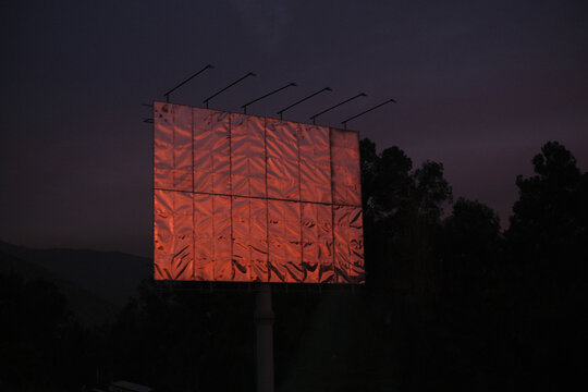 Blank roadside metal billboard at sunset, Chile