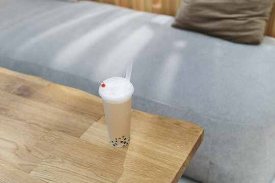 Close-up overhead view of a cappuccino bubble coffee with tapioca pearls on a table