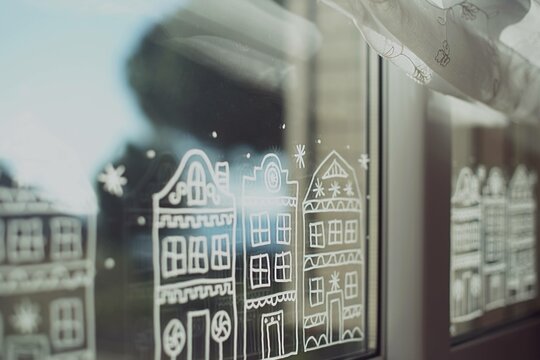 Close-up of rows of Gingerbread houses painted on a window