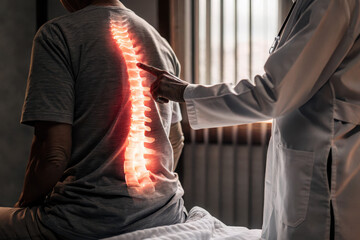 A doctor examines a patient's spine, highlighting potential issues with a glowing illustration, emphasizing the importance of spinal health.