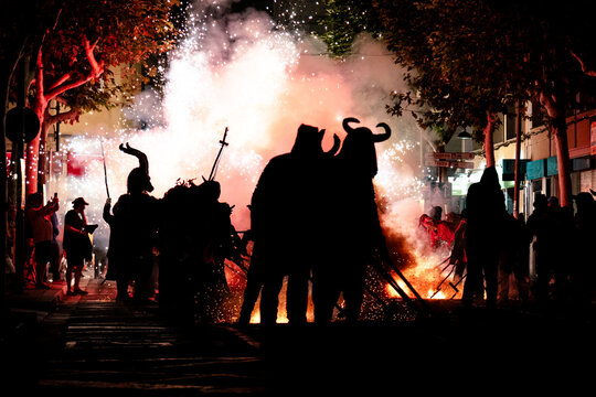 Silhouette of people in masks at a Traditional fire festival, Catalonia, Spain