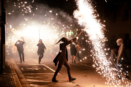 Silhouette of people in masks at a Traditional fire festival, Catalonia, Spain