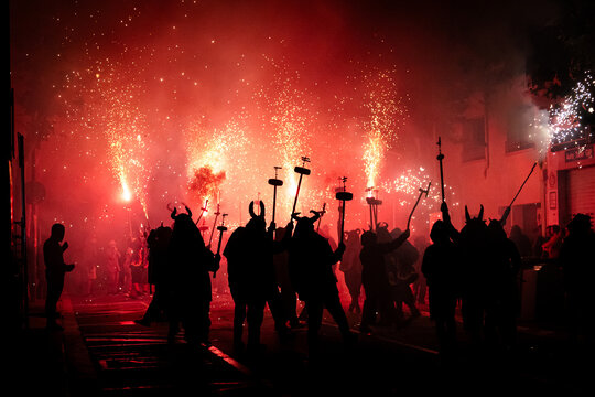 Silhouette of people in masks at a Traditional fire festival, Catalonia, Spain