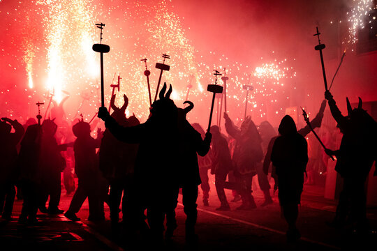 Silhouette of people in masks at a Traditional fire festival, Catalonia, Spain
