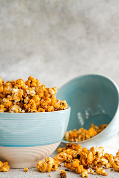 Close-up of an overflowing bowl of Sweet caramel popcorn on a table