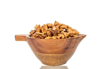 Shelled walnuts on a wooden plate, close-up, isolated on a white background.