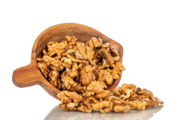 Shelled walnuts on a wooden plate, close-up, isolated on a white background.
