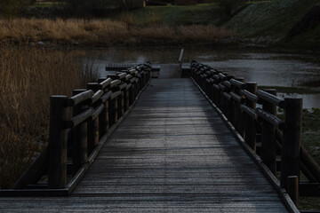 Massive wooden bridge leading to river. Kandava town, Latvia