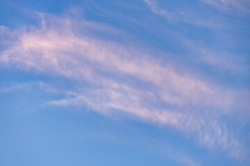 A beautiful sky tinted by the sun leaving vibrant shades of gold, pink, blue and multicolored. Clouds in the twilight evening and morning sky. Cloudy sky background in the evening, and during the day.