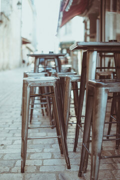 High Metal Tables and bar stools outside a street cafe, Orleans, Centre-Val de Loire, France
